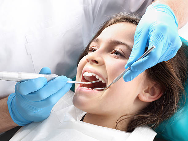 Child in the dental chair dental treatment during surgery. Child in the dental chair dental treatment during surgery.